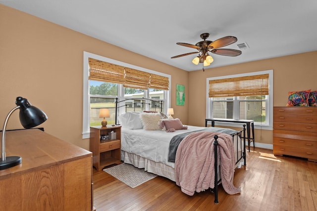 bedroom with ceiling fan and light hardwood / wood-style flooring