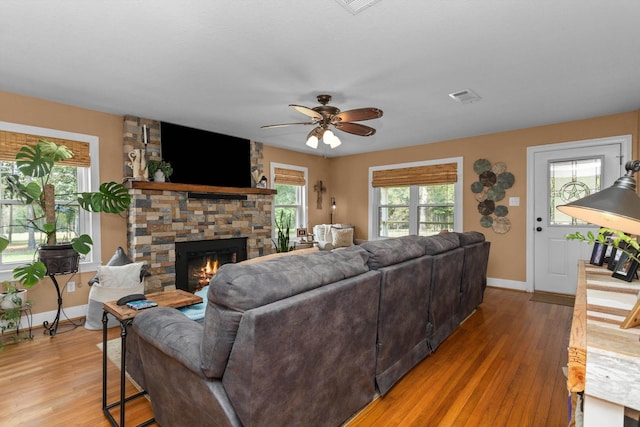 living room featuring a wealth of natural light, hardwood / wood-style floors, and a fireplace