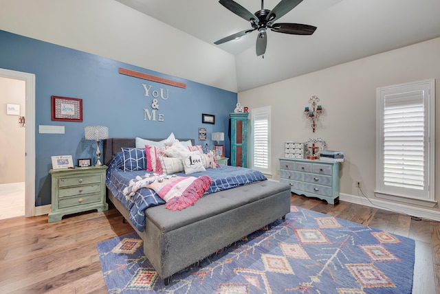 bedroom featuring hardwood / wood-style flooring, ceiling fan, and lofted ceiling