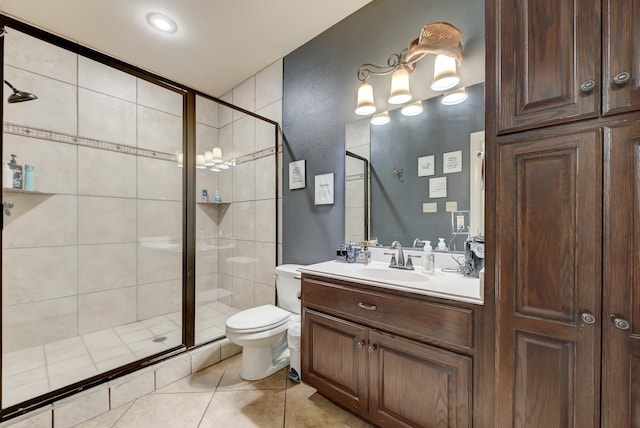 bathroom with tile patterned floors, vanity, toilet, and an enclosed shower