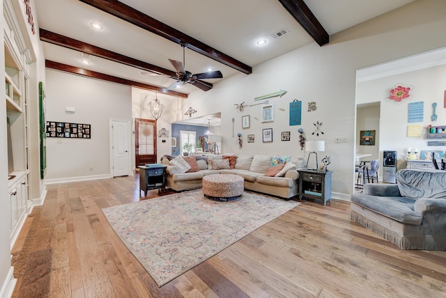 living room with beam ceiling, ceiling fan, and light hardwood / wood-style flooring