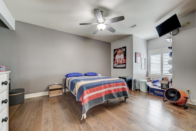 bedroom with wood-type flooring and ceiling fan