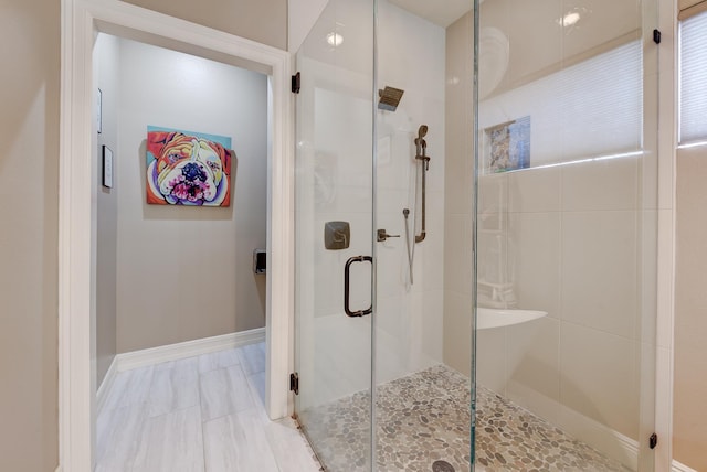 bathroom with a shower with shower door