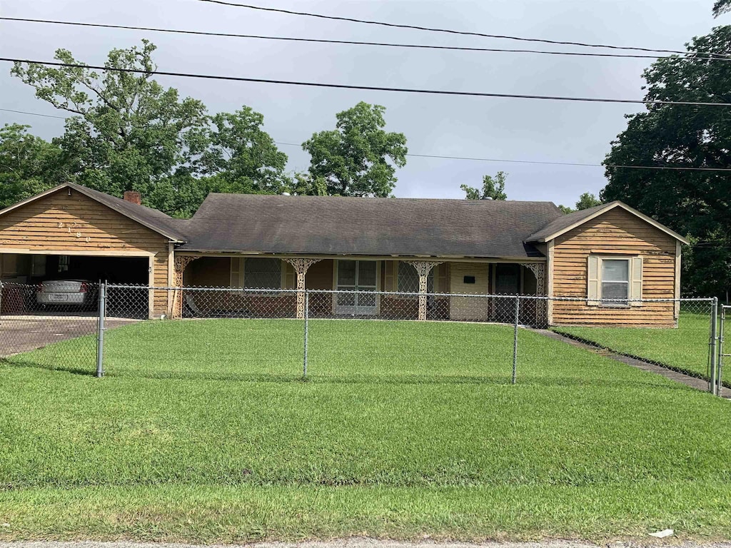 2180 Tyler St, Beaumont, TX 77703 - ranch-style house featuring concrete driveway, an attached garage, and a chimney