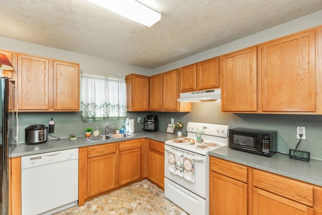 kitchen featuring a textured ceiling, white appliances, and sink