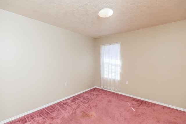 carpeted spare room featuring a textured ceiling