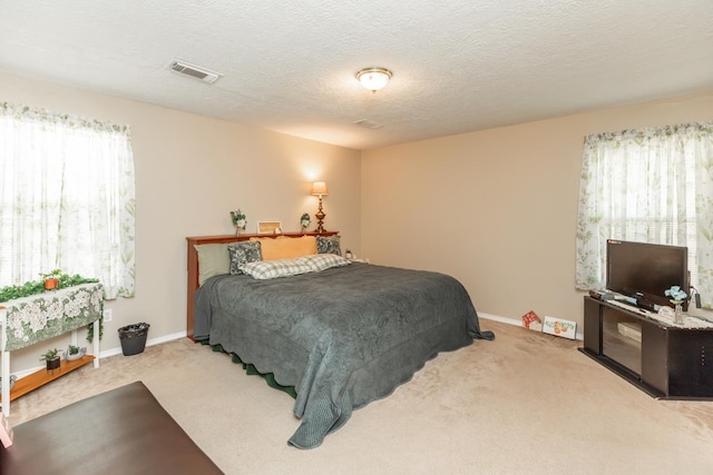 carpeted bedroom featuring a textured ceiling