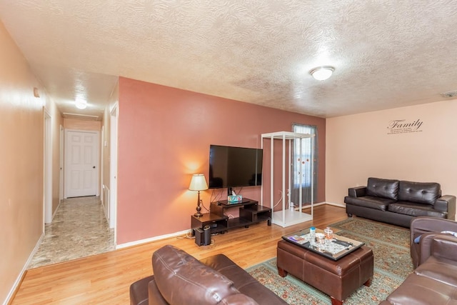 living room with a textured ceiling and hardwood / wood-style flooring