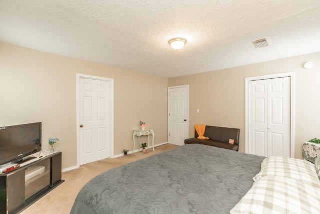 carpeted bedroom with a textured ceiling