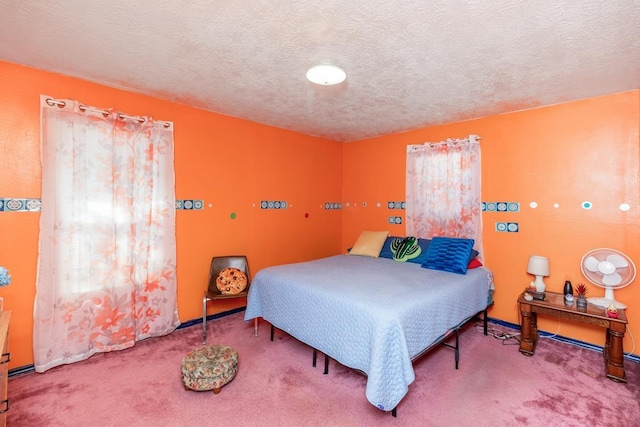 carpeted bedroom featuring a textured ceiling