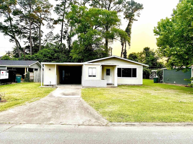 3025 19th St, Beaumont, TX 77706 - view of front of home featuring concrete driveway, a front lawn, and a carport