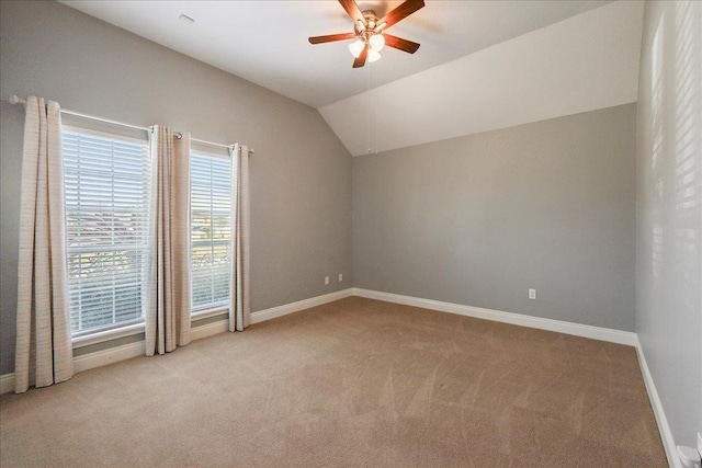 interior space featuring vaulted ceiling, light carpet, and ceiling fan