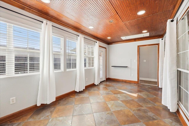 empty room with crown molding and wood ceiling