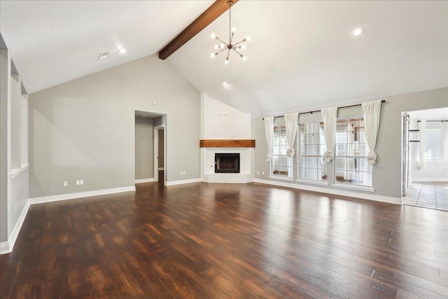 unfurnished living room featuring beamed ceiling, a brick fireplace, dark wood-type flooring, and a notable chandelier