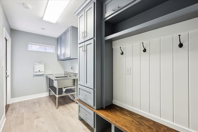 mudroom featuring light hardwood / wood-style flooring and a textured ceiling