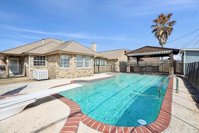 view of pool featuring a gazebo, central AC unit, a patio area, and a diving board