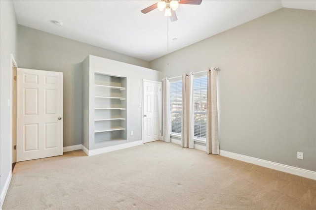 unfurnished bedroom featuring ceiling fan, light colored carpet, and lofted ceiling