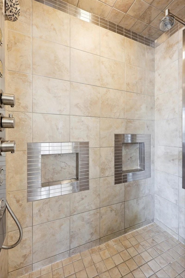 bathroom featuring a fireplace and a tile shower