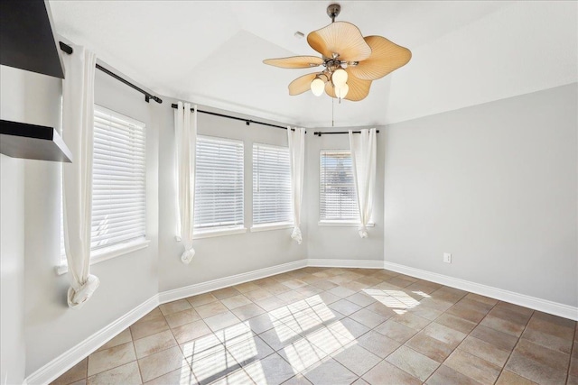 tiled spare room with ceiling fan