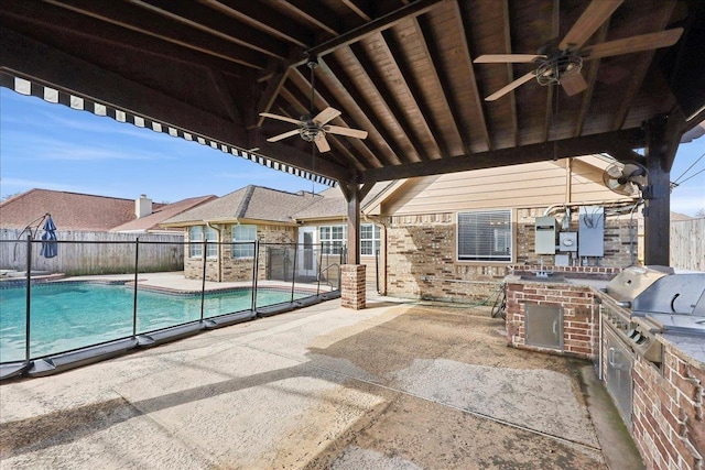 view of patio / terrace with ceiling fan, area for grilling, a grill, and a fenced in pool