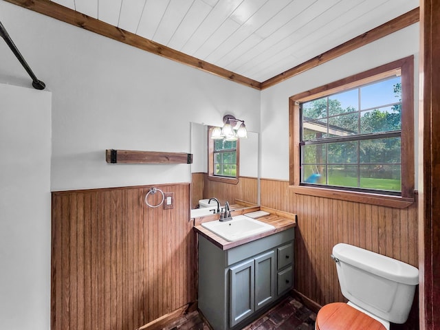9378 Cocklebur Loop, Silsbee, TX 77656 - bathroom featuring a wainscoted wall, wooden walls, healthy amount of natural light, vanity, and wood ceiling
