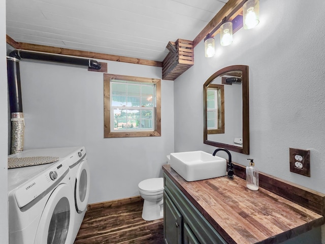 9378 Cocklebur Loop, Silsbee, TX 77656 - bathroom featuring washer and clothes dryer, wood finished floors, and vanity