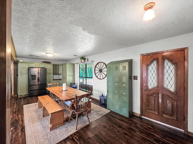 9378 Cocklebur Loop, Silsbee, TX 77656 - dining area featuring dark wood-style floors and a textured ceiling