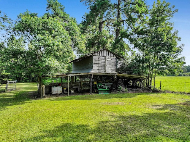 9378 Cocklebur Loop, Silsbee, TX 77656 - view of grassy yard featuring view of scattered trees and an outbuilding