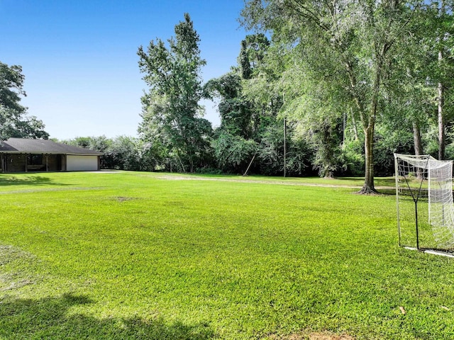 9378 Cocklebur Loop, Silsbee, TX 77656 - view of yard featuring a garage