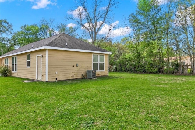 view of home's exterior with central air condition unit and a lawn