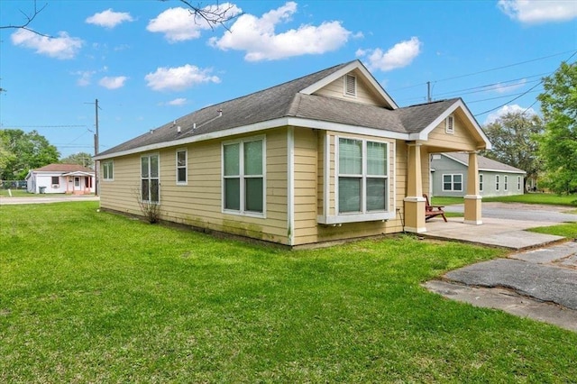 view of home's exterior with a lawn and a patio