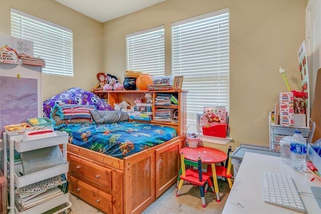 bedroom featuring multiple windows and light carpet