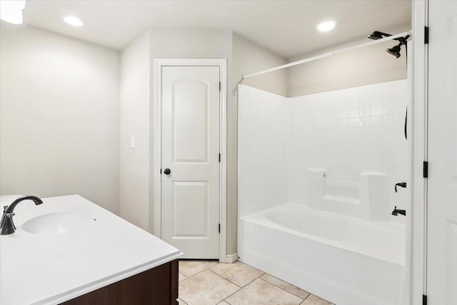 bathroom with washtub / shower combination, vanity, and tile patterned floors