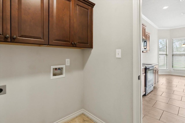 washroom featuring hookup for an electric dryer, washer hookup, cabinets, crown molding, and light tile patterned floors