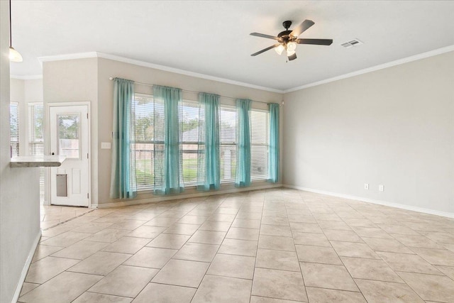 tiled empty room with ceiling fan and crown molding