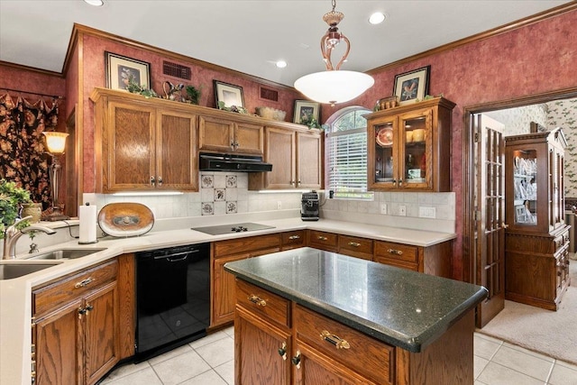 kitchen with backsplash, ornamental molding, sink, black appliances, and a center island