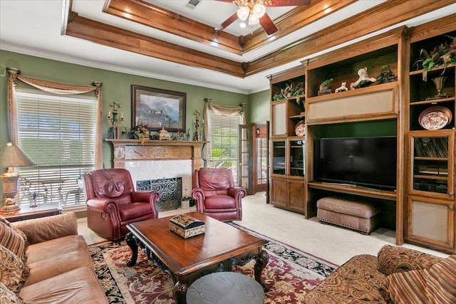 living room featuring carpet floors, a raised ceiling, and ornamental molding