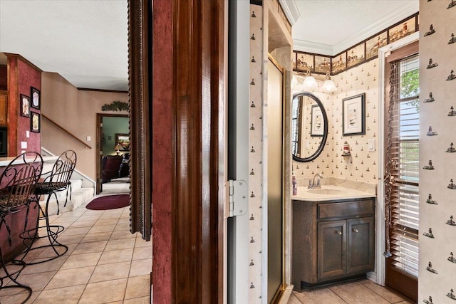 bathroom featuring tile patterned floors, vanity, and crown molding