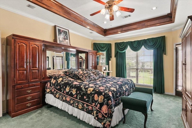 bedroom featuring ornamental molding, light colored carpet, ceiling fan, and a tray ceiling