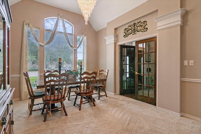 sitting room with lofted ceiling, light colored carpet, french doors, and a chandelier