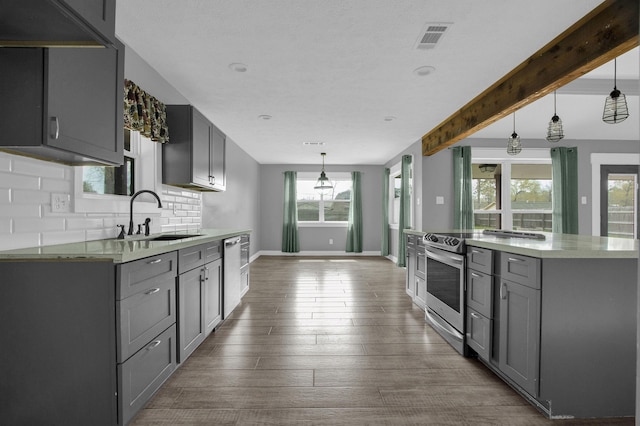 kitchen featuring gray cabinetry, decorative light fixtures, and sink