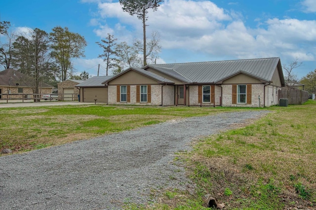 single story home with central AC and a front yard