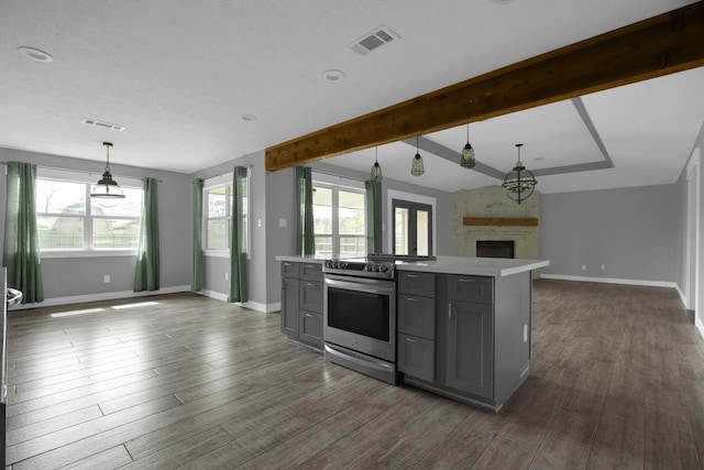 kitchen with pendant lighting, electric range, a center island, gray cabinets, and dark hardwood / wood-style floors