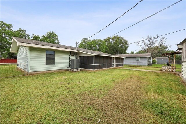 275 E Clover Ln, Bridge City, TX 77611 - back of property featuring a sunroom and central AC unit
