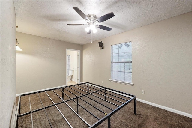275 E Clover Ln, Bridge City, TX 77611 - unfurnished bedroom featuring a textured wall, carpet, a textured ceiling, baseboards, and connected bathroom