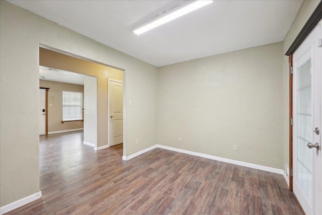 275 E Clover Ln, Bridge City, TX 77611 - spare room with wood finished floors and baseboards
