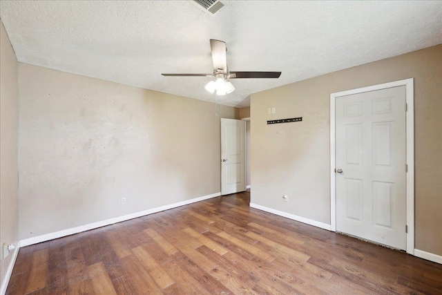 275 E Clover Ln, Bridge City, TX 77611 - unfurnished bedroom with wood finished floors, baseboards, a textured ceiling, and a ceiling fan