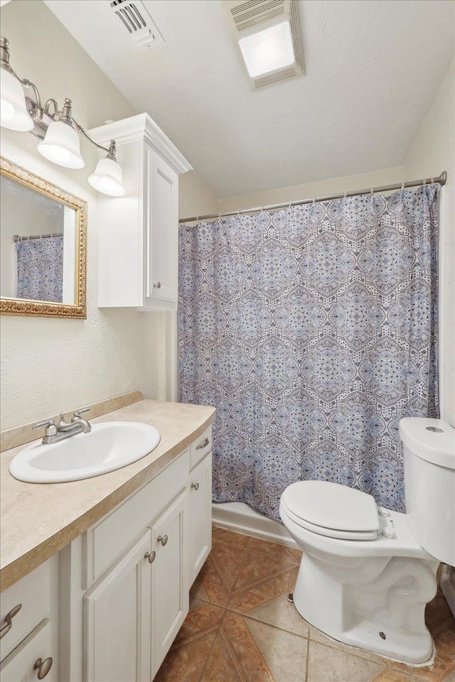275 E Clover Ln, Bridge City, TX 77611 - bathroom featuring toilet, vanity, tile patterned floors, and a shower with curtain