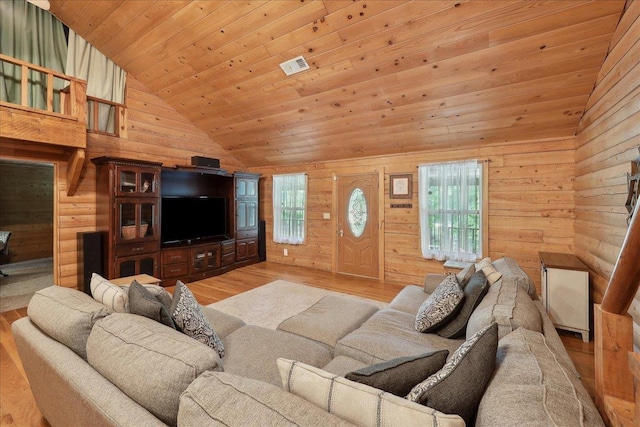 9570 Skeeter Dr, Orange, TX 77632 - living room with light wood finished floors, wood walls, plenty of natural light, wood ceiling, and high vaulted ceiling