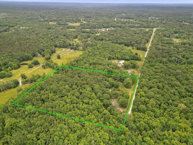 9570 Skeeter Dr, Orange, TX 77632 - aerial view of property's location featuring a heavily wooded area and property parcel outlined